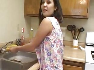 Latin houswife gives a blowjob to her busband in a kitchen