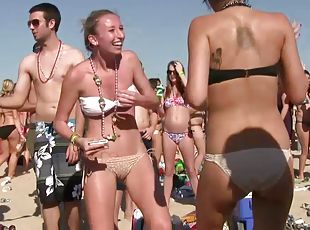 Babes at the beach party showing off ass and tits in bikini