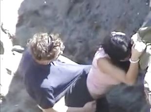 Black dude plays with some sleeping girl's pussy on a beach