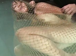 Keeani Lei gets wrapped in the net and thrown in the water
