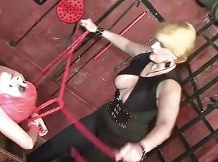 In dungon with lesbian for bondage and hot wax play