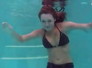 Redhead in cute bikini goes swimming