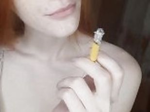 redhead girl smokes a cigarette