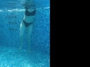 A Russian is swimming in the pool. view of pd with water on a naked girl