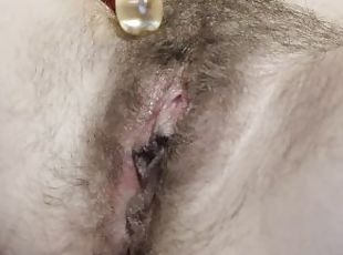 Hairy bushy pussy playing with glass dildo on last day of period before shaving.