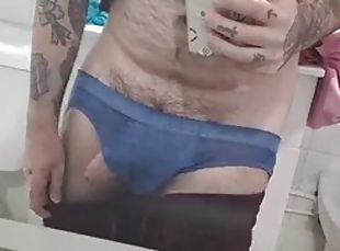 Hairy boy undresses in front of the mirror and jerks off