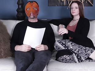 Jessica Kay talks with a masked man backstage at a fetish porn set