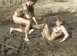 Muddy couple having fun doing each other showing how dirty they are