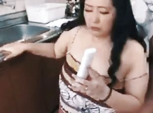Japanese housewife gets fucked in the kitchen