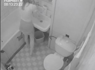 A girl moans wildly while fucking herself in the bathroom