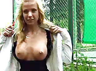 Blonde flashes her incredible tits outdoors