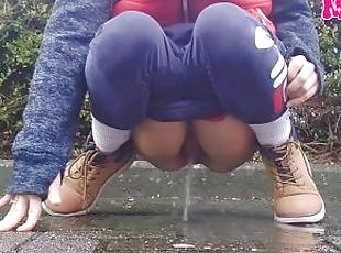 Amateur girl pees in the street